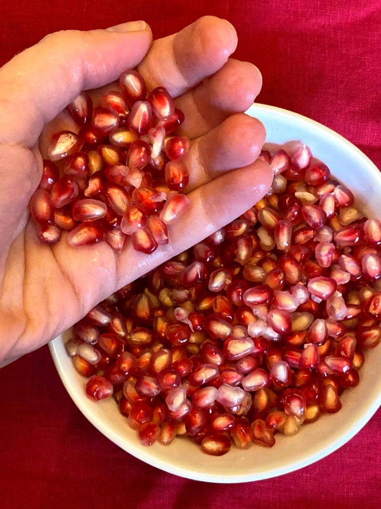 Hand showing how to cut a pomegranate correctly
