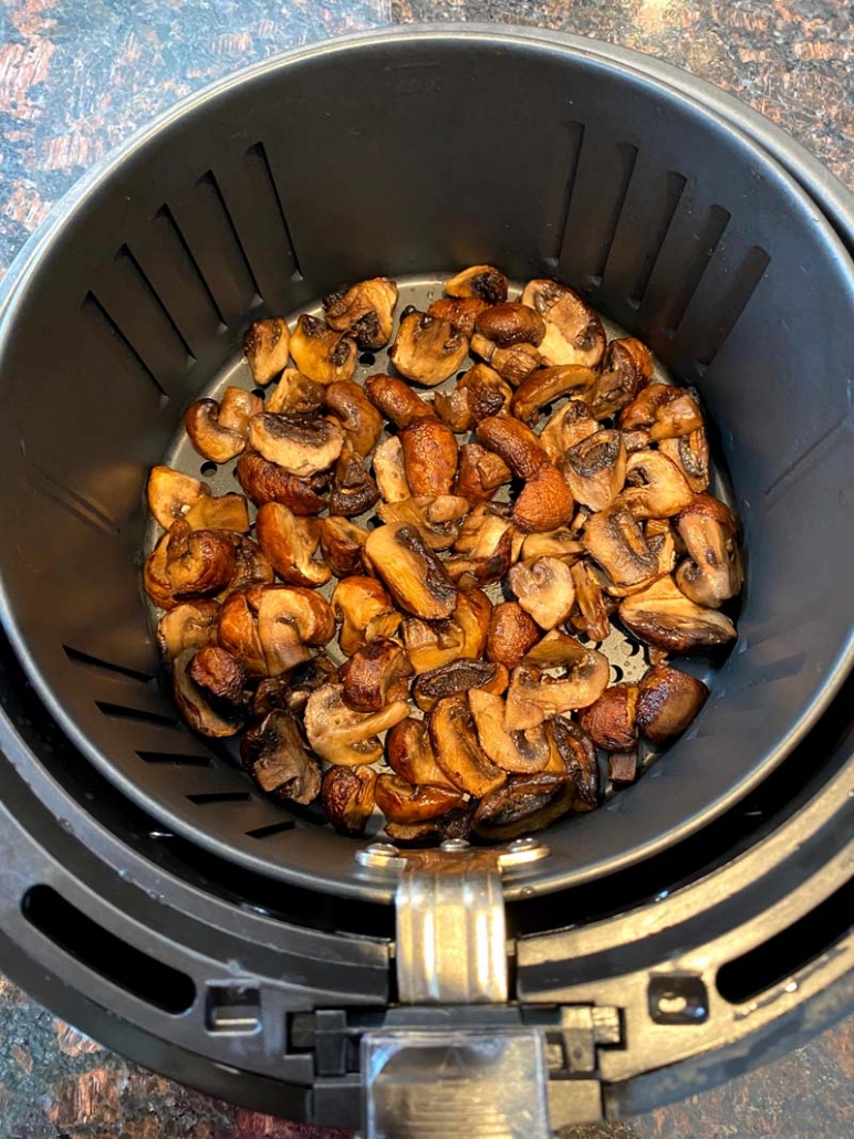 cooked sliced mushrooms in the air fryer basket