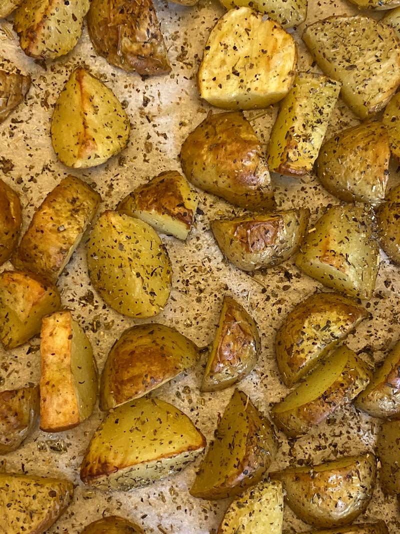 Parchment paper covered with herb roasted potatoes