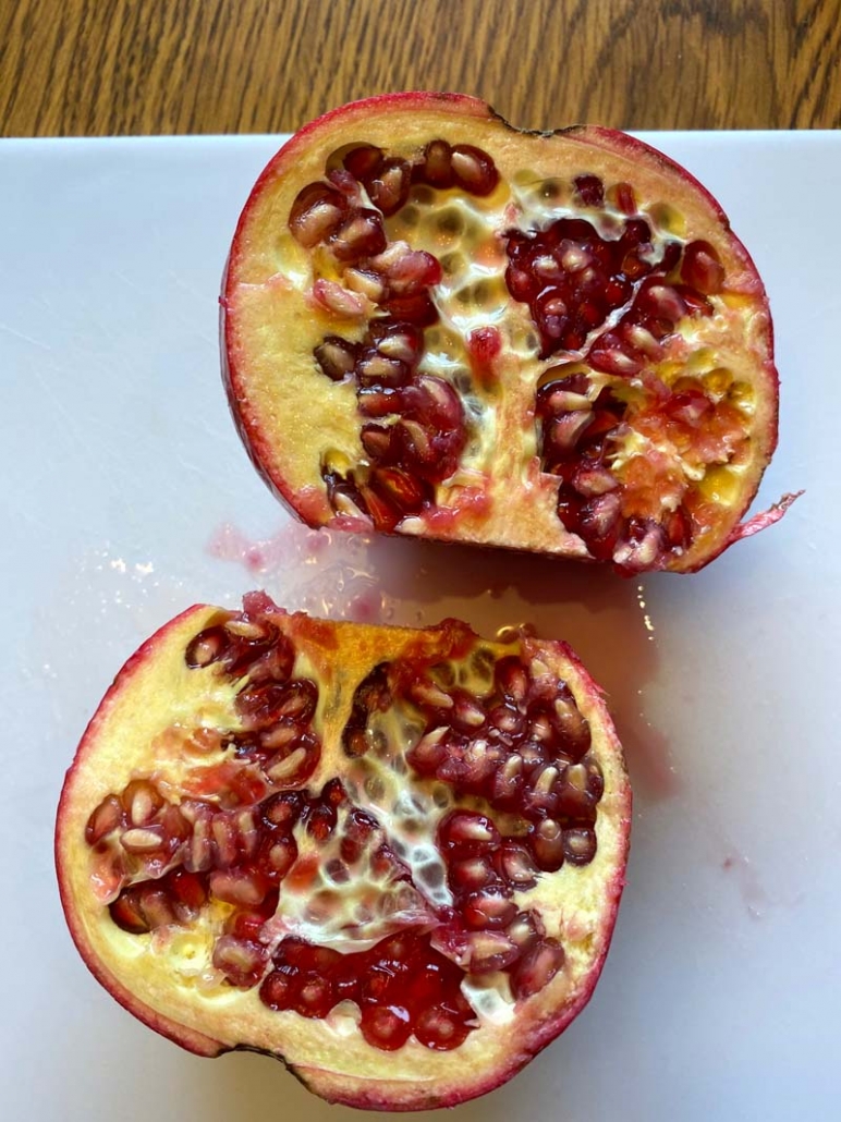 pomegranate cut in half showing seeds