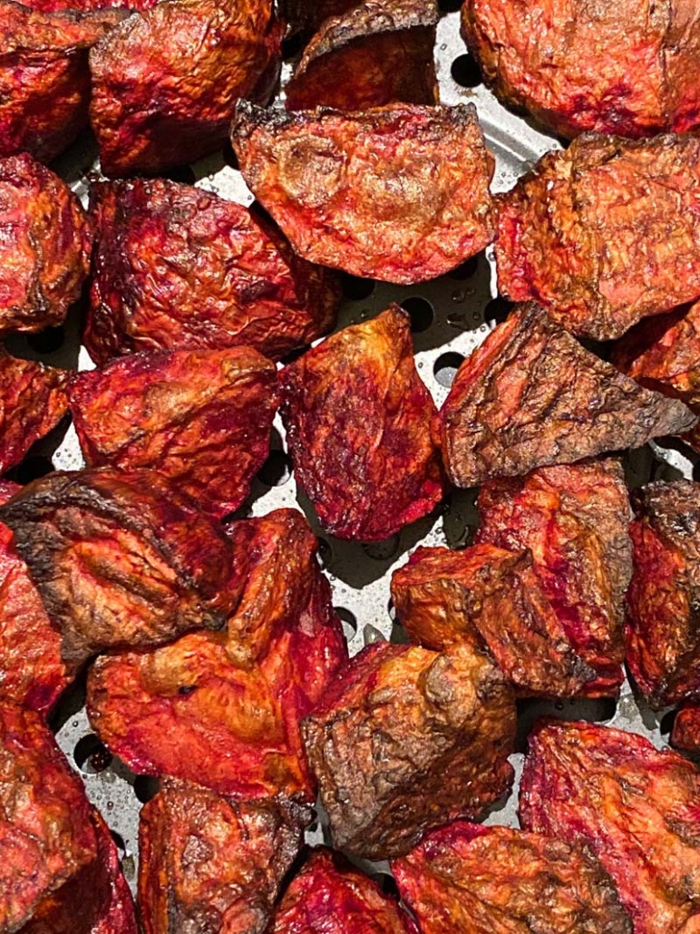 air fryer roasted beets at the bottom of an air fryer basket