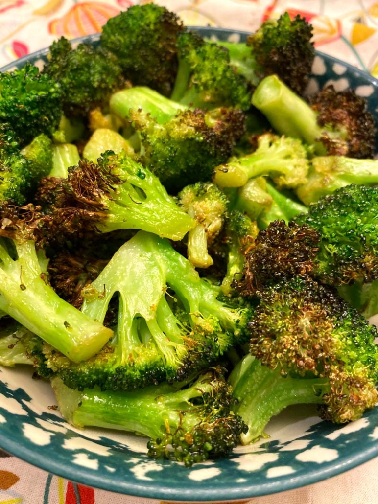 roasted broccoli in a blue and white bowl 