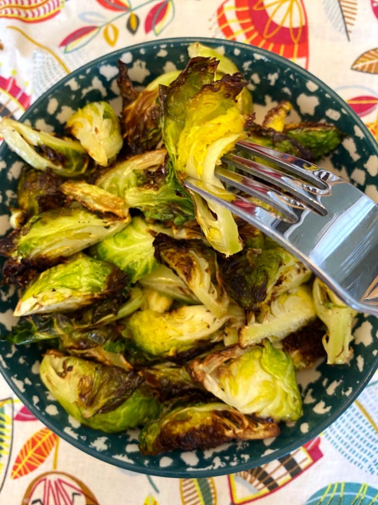 eating fried brussel sprouts with a fork