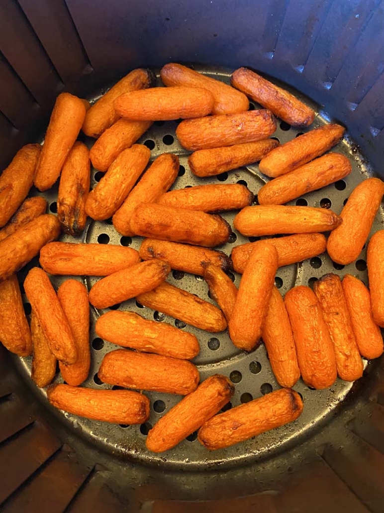 roasted baby carrots in an air fryer basket