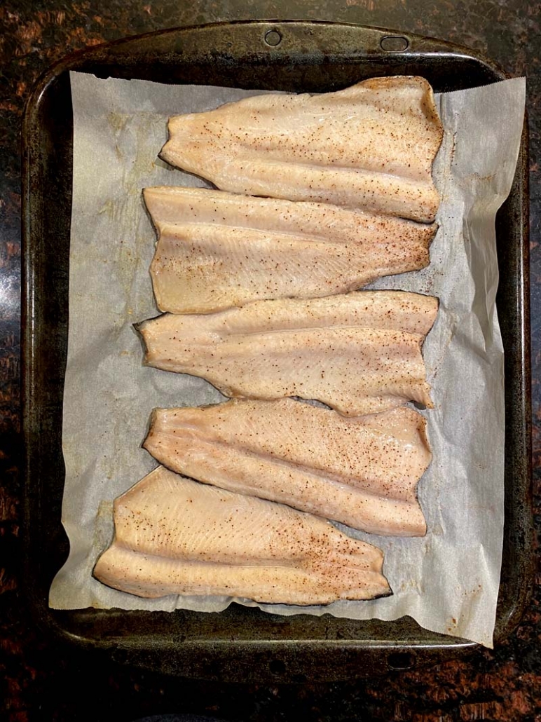 baked rainbow trout on a baking sheet