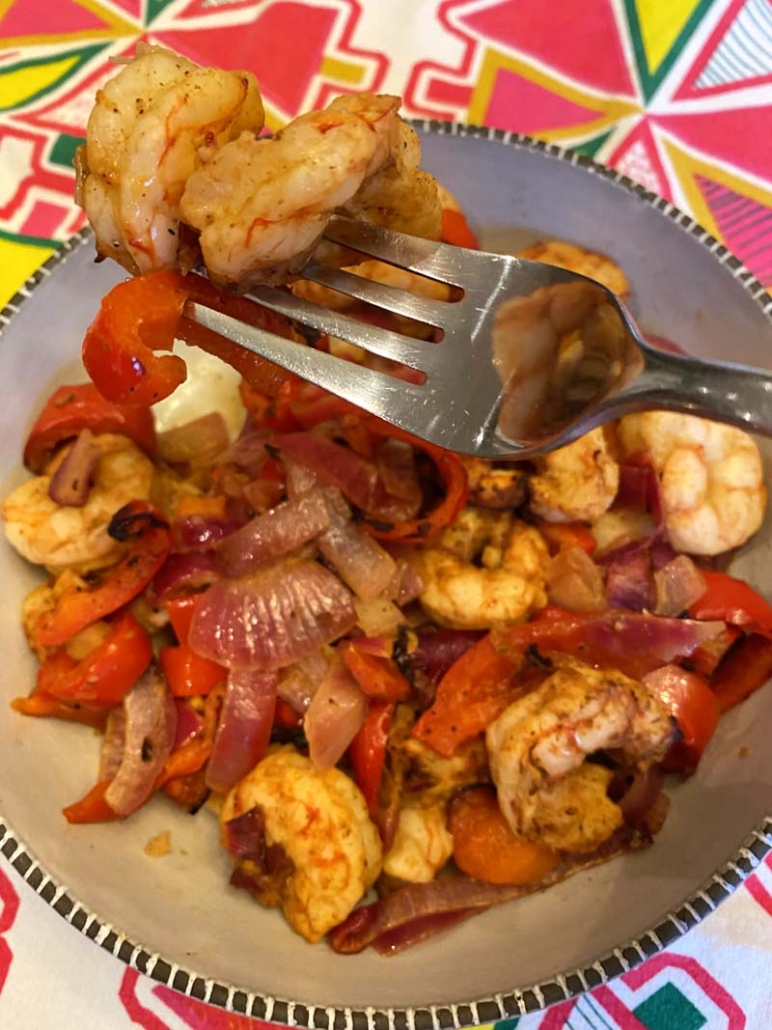 eating shrimp with red peppers and onions