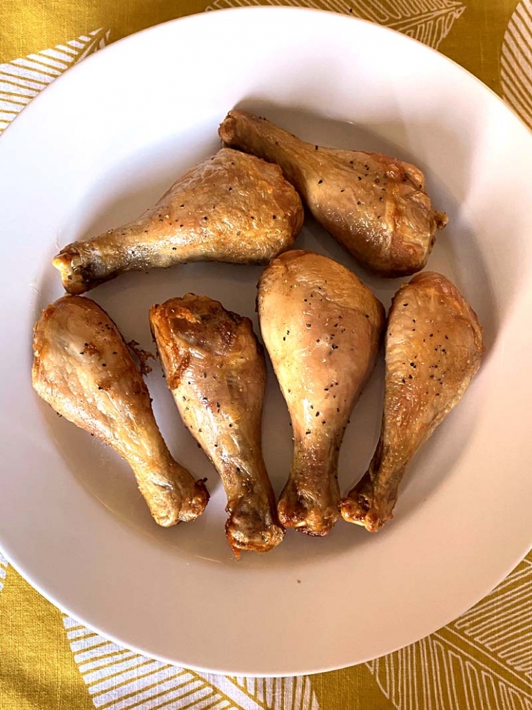 Air fryer chicken legs on a white plate 