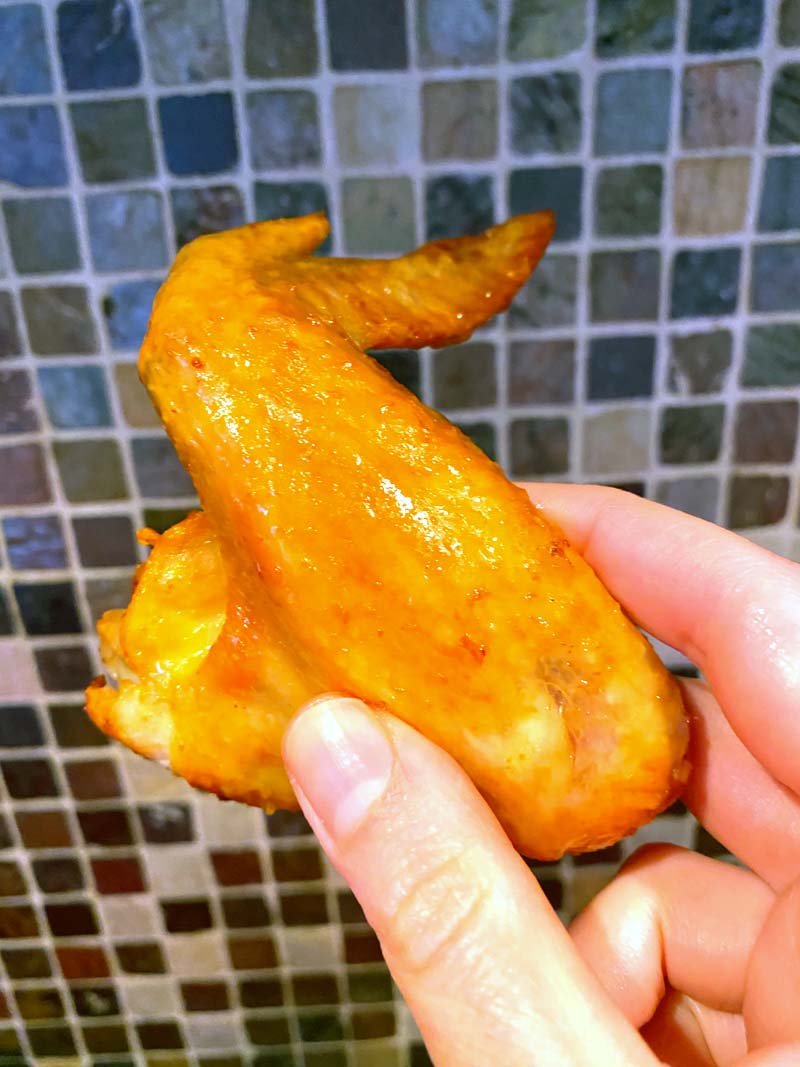 Holding a chicken wing