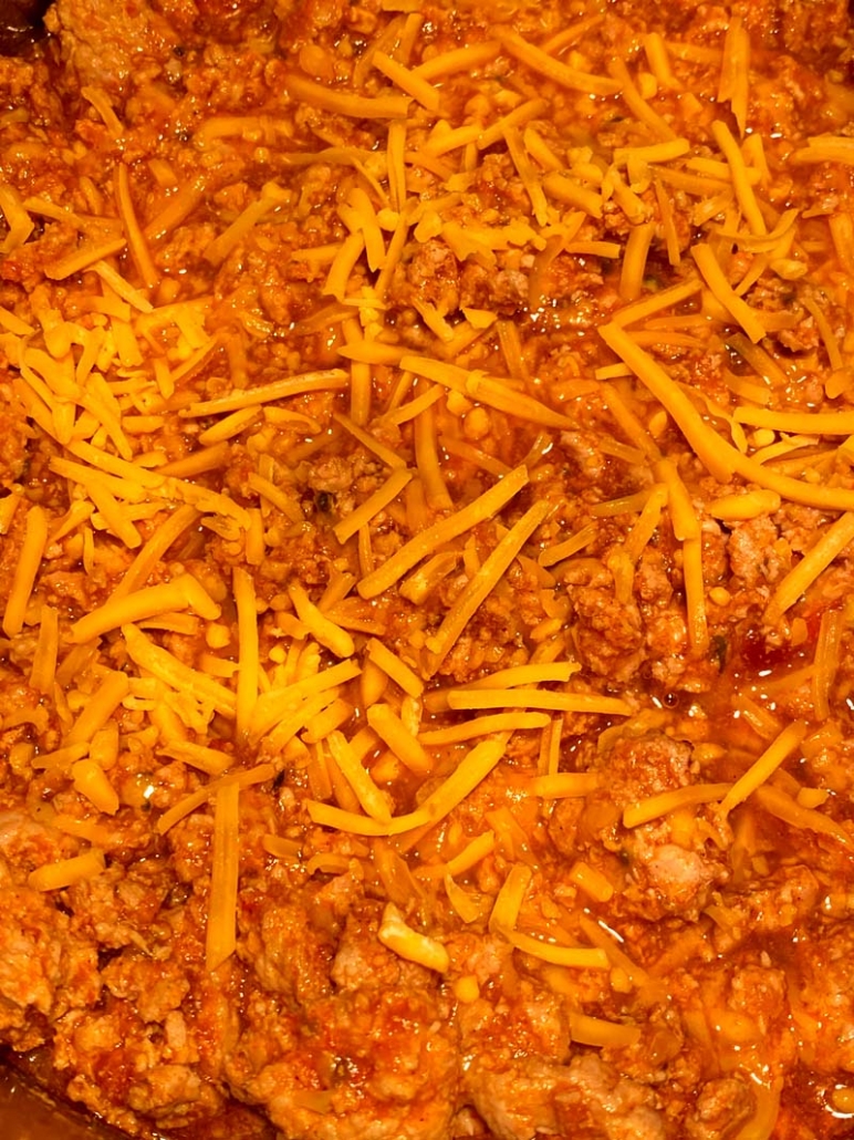ground beef chili with shredded cheddar cheese