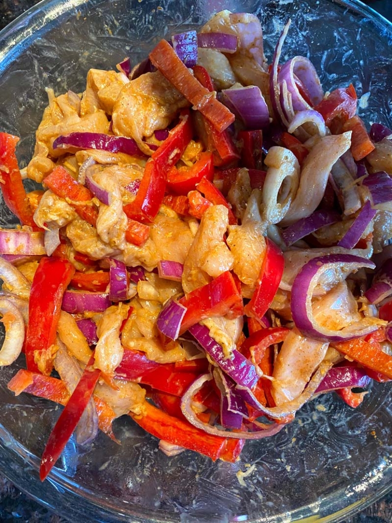 adding chicken marinade with lime juice, olive oil and chili seasoning