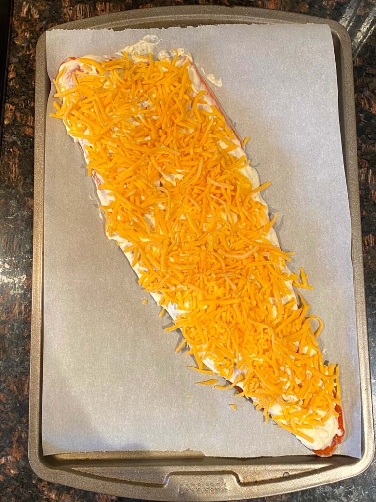 salmon sprinkled with shredded cheddar cheese