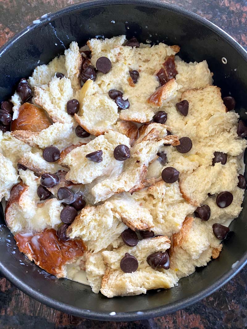 chocolate chips added to the bread in a pan