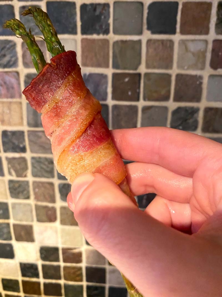 eating bacon wrapped asparagus