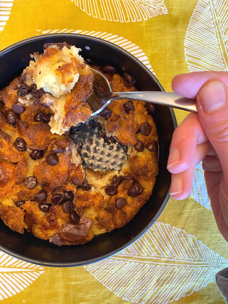 A spoon serving up the bread pudding