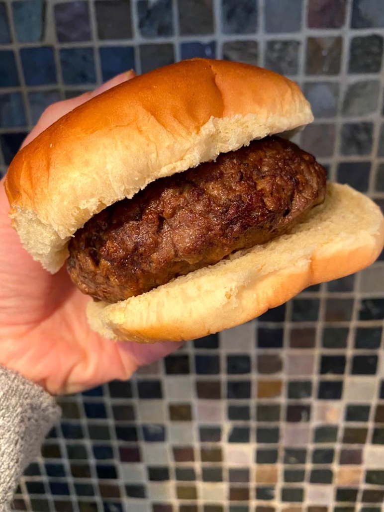 cooked hamburger patty on a brioche bun 