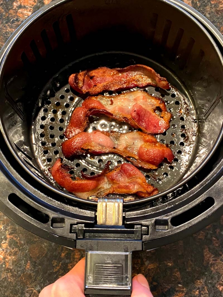 opened air fryer with bacon