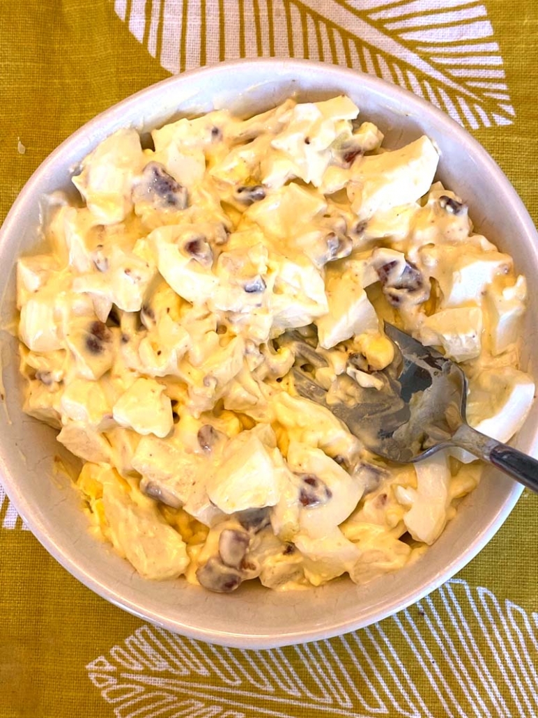 egg salad with bacon in a white bowl