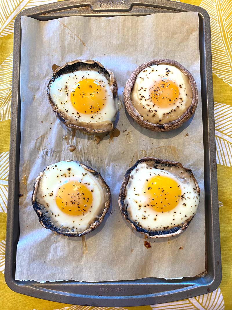 The baked portobellos with eggs on a baking sheet