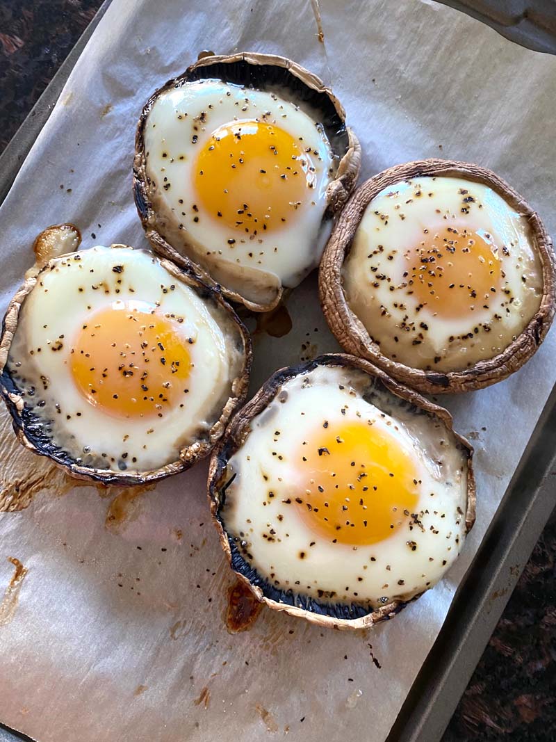 Four baked eggs in mushrooms ready to serve