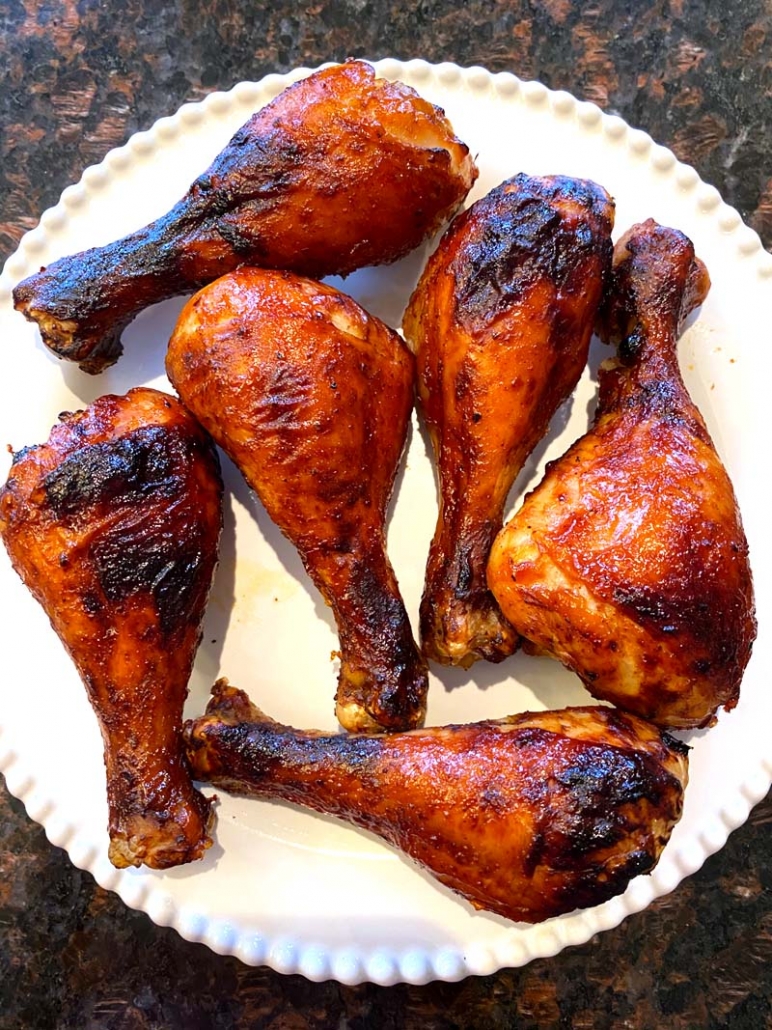BBQ chicken legs on a white plate 
