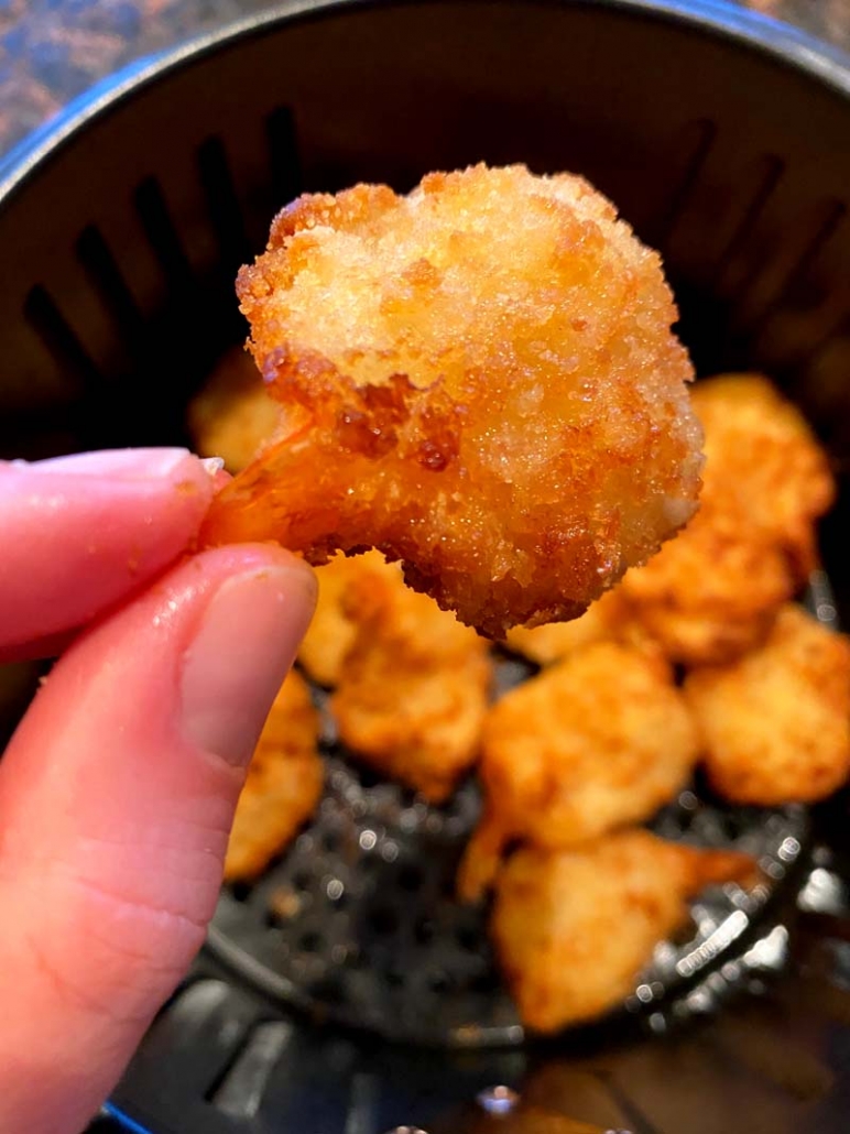 holding a fried shrimp 