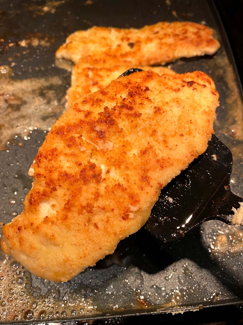 Turning over the chicken breast with a spatula