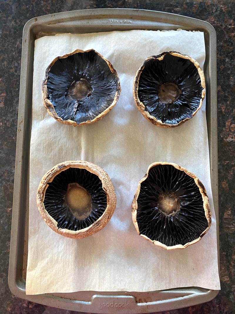 The mushroom caps on a baking sheet