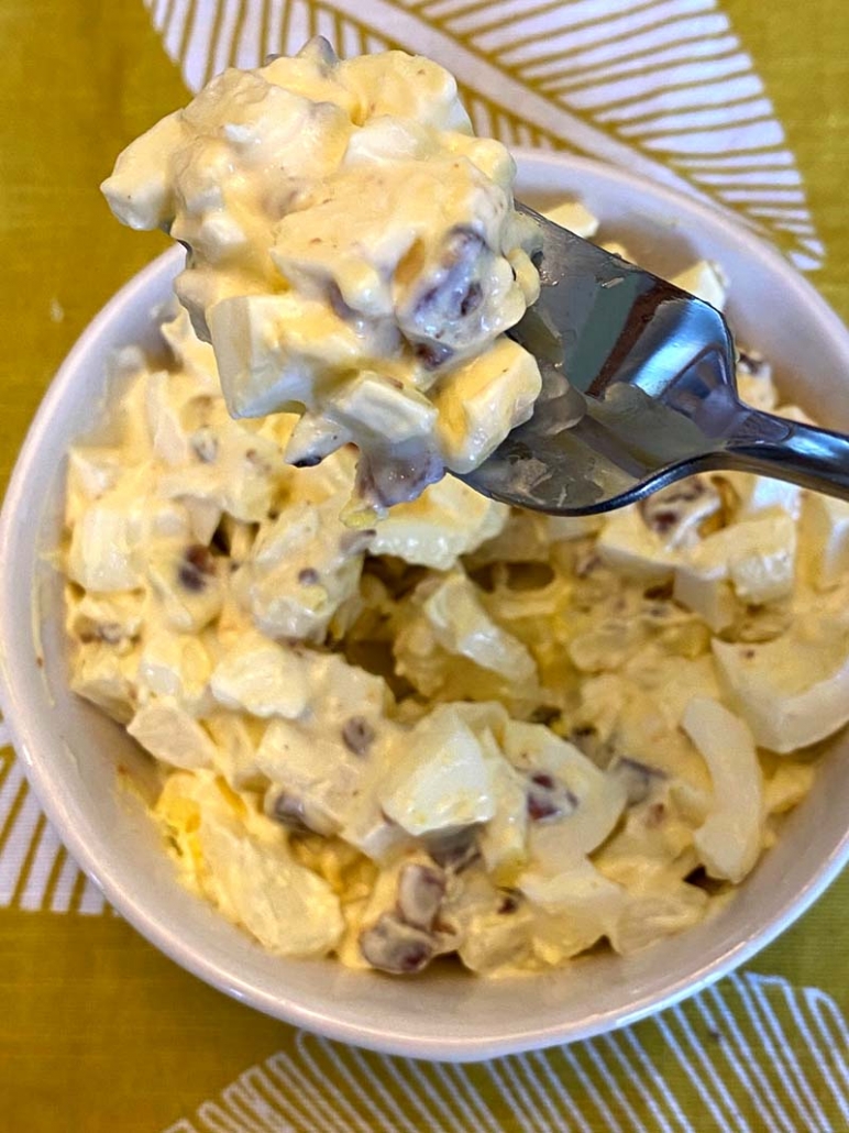 a scoop of egg salad with a fork