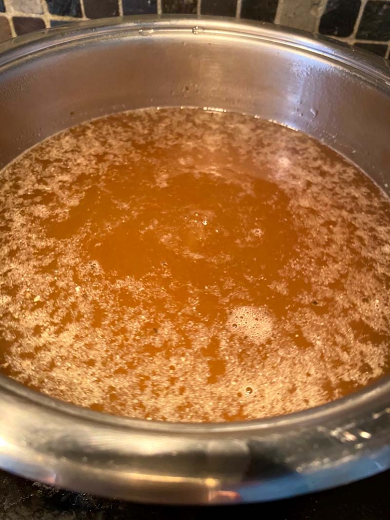boiling chicken broth in a pot