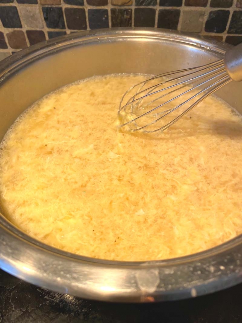 mixing in eggs into broth
