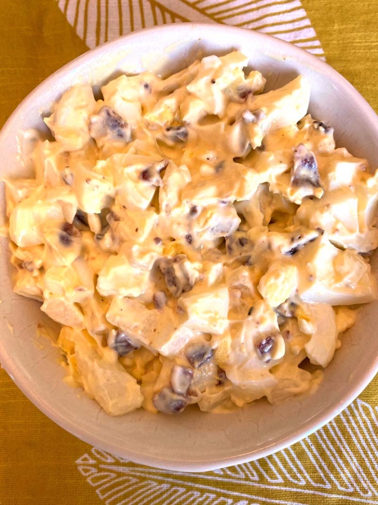 ready to eat egg salad with bacon in a white bowl
