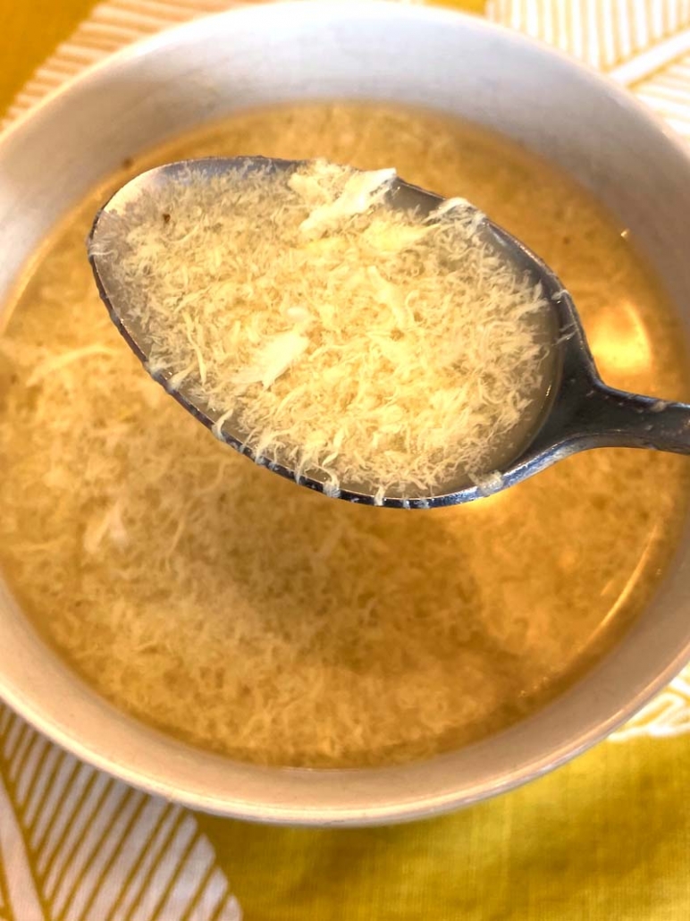 eating egg drop soup with a spoon 