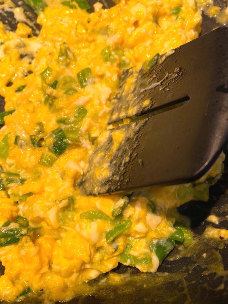 using a spatula to scramble eggs