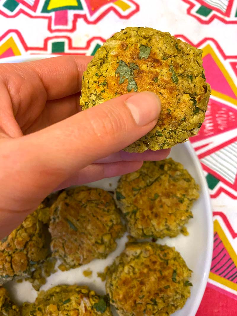 Taking a falafel from a plate