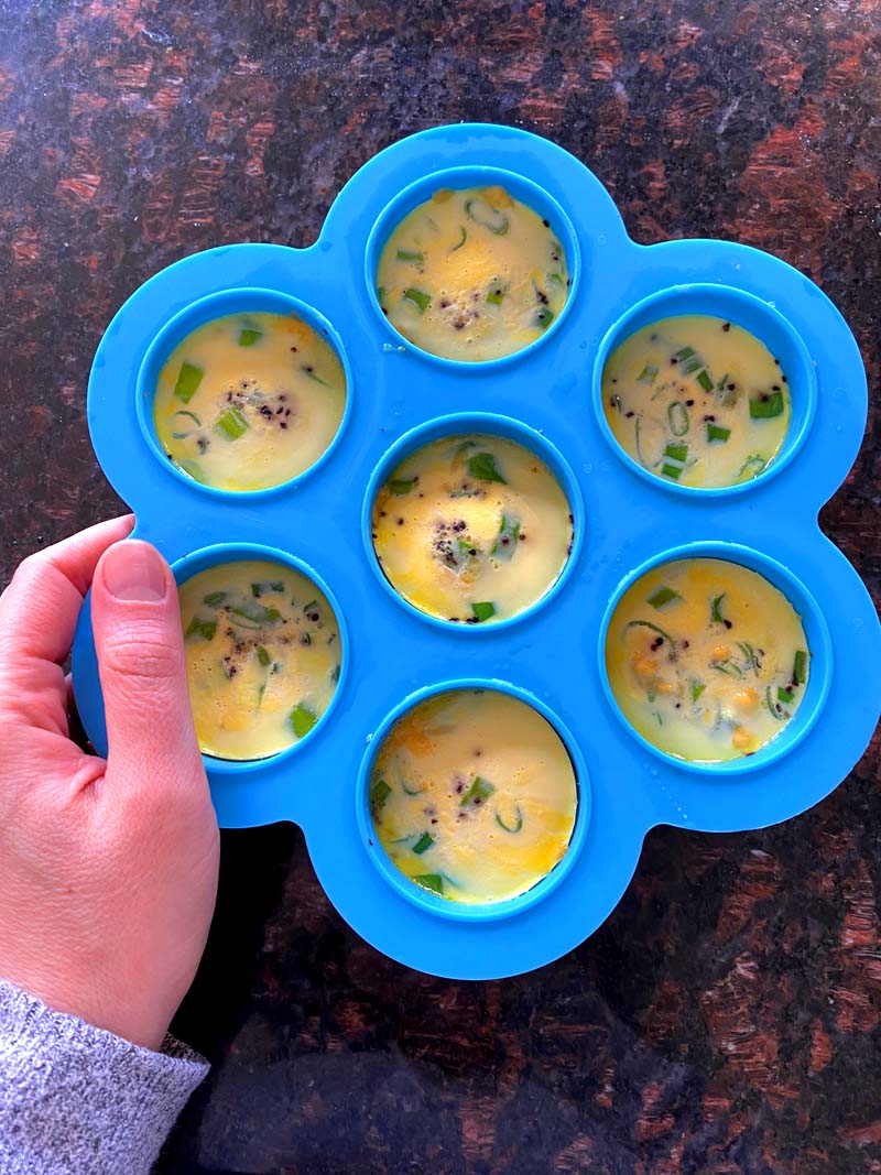 Holding the mold with the egg bites