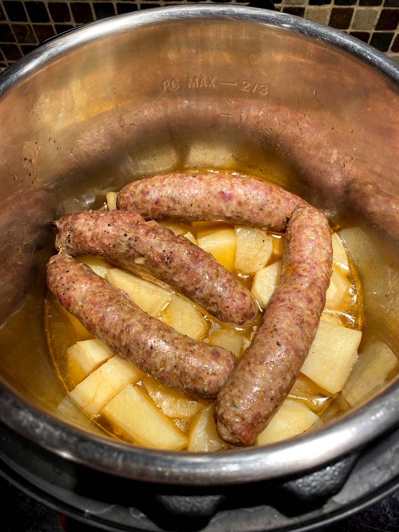 Potatoes and sausages in a pressure cooker