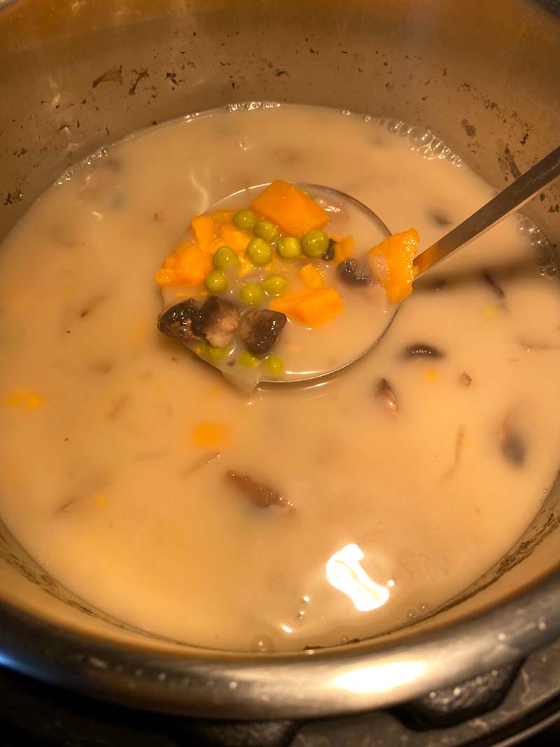 A ladle in the mushroom sweet potato soup