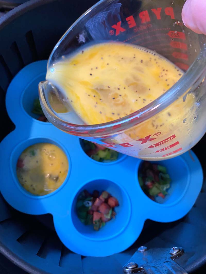 The egg mixture being poured into the mold