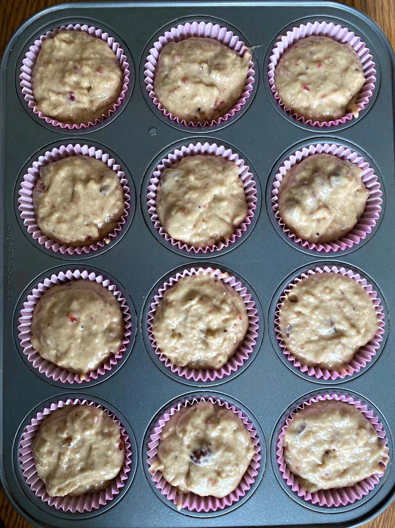 The muffin batter in liners before being baked