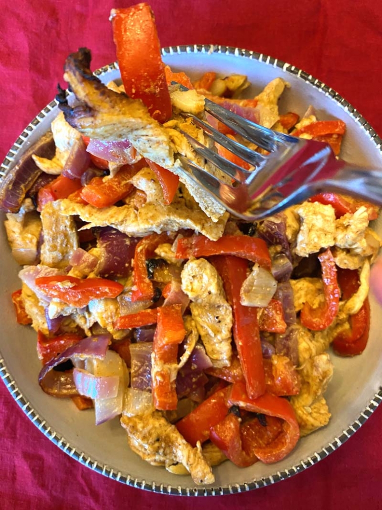 eating chicken with peppers and onions