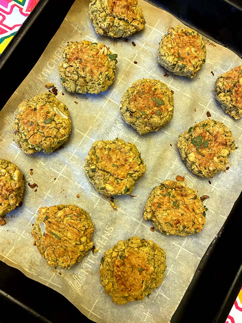 The baked falafels on a baking tray lined with parchment