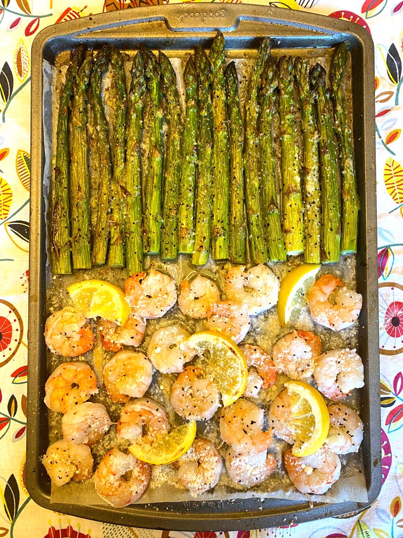 Overhead shot of shrimp and asparagus on a sheet pan