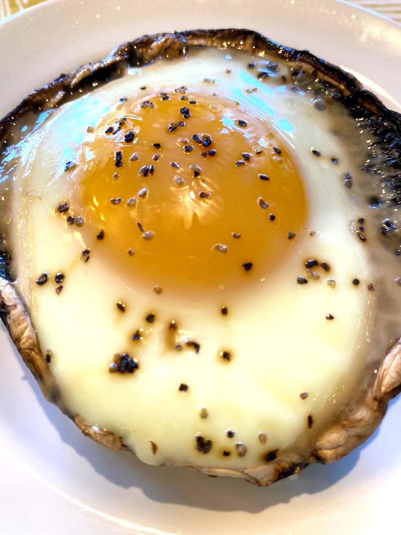Close up of a portobello with baked egg