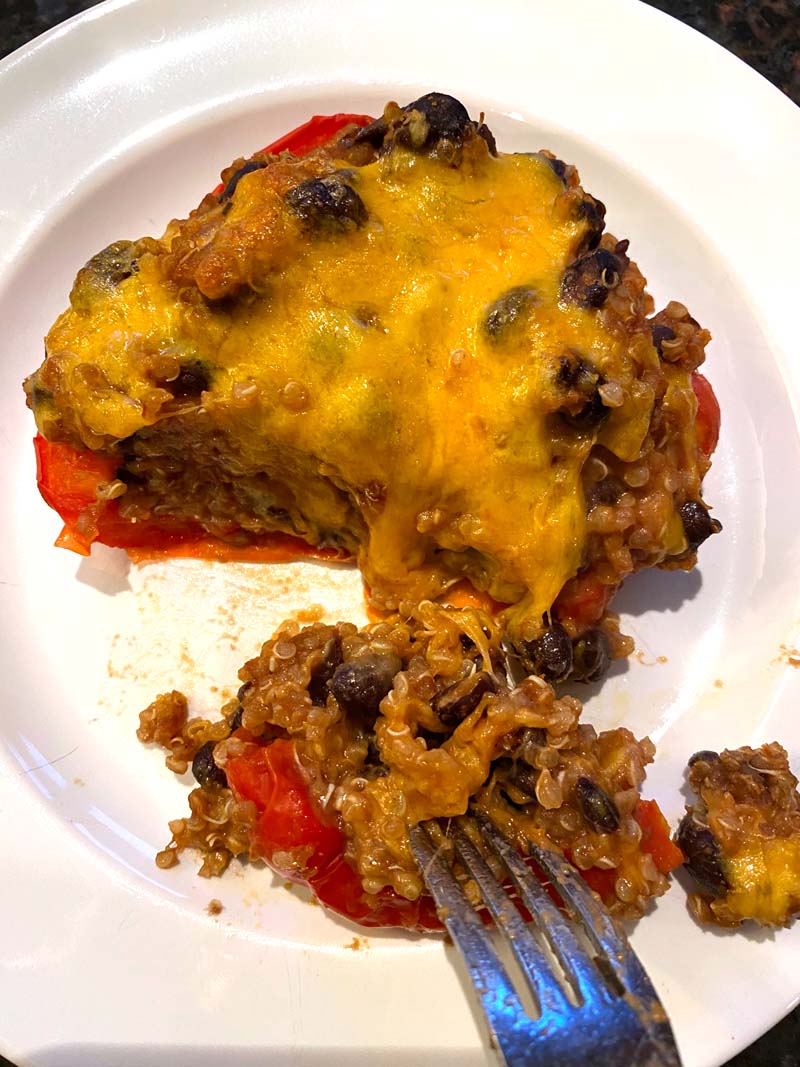 A fork cutting off a piece of the stuffed pepper