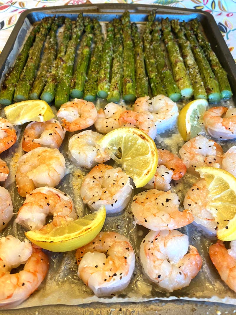 The seasoned shrimp on a sheet pan