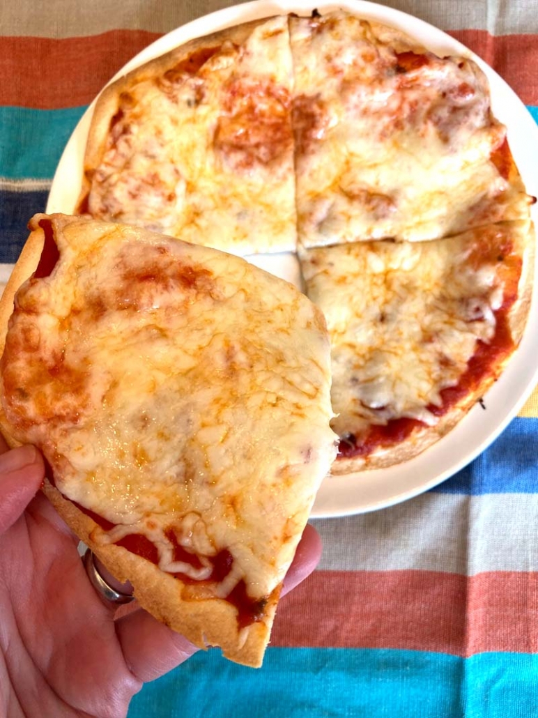 taking a slice of homemade cheese pizza
