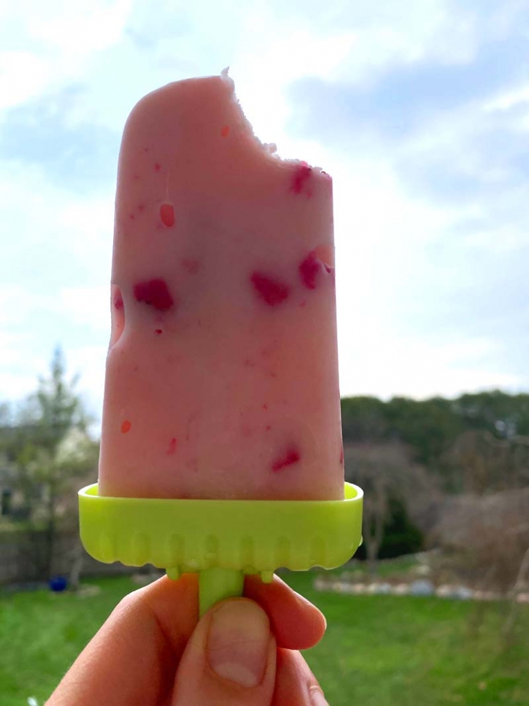 taking a bite out of a strawberry frozen yogurt