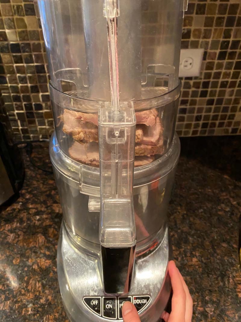 adding thick slices of beef to food processor