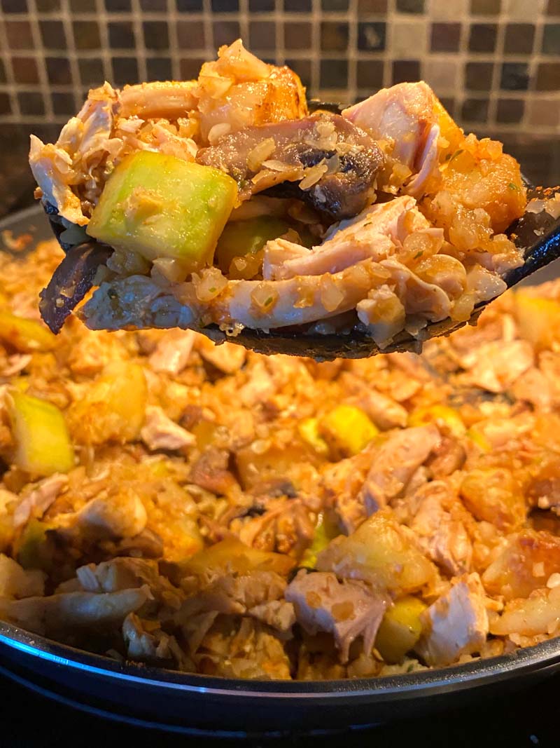 The cauliflower stir fry being served on a spatula