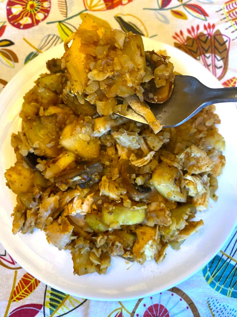 Close up of a fork in the cauliflower rice stir fry